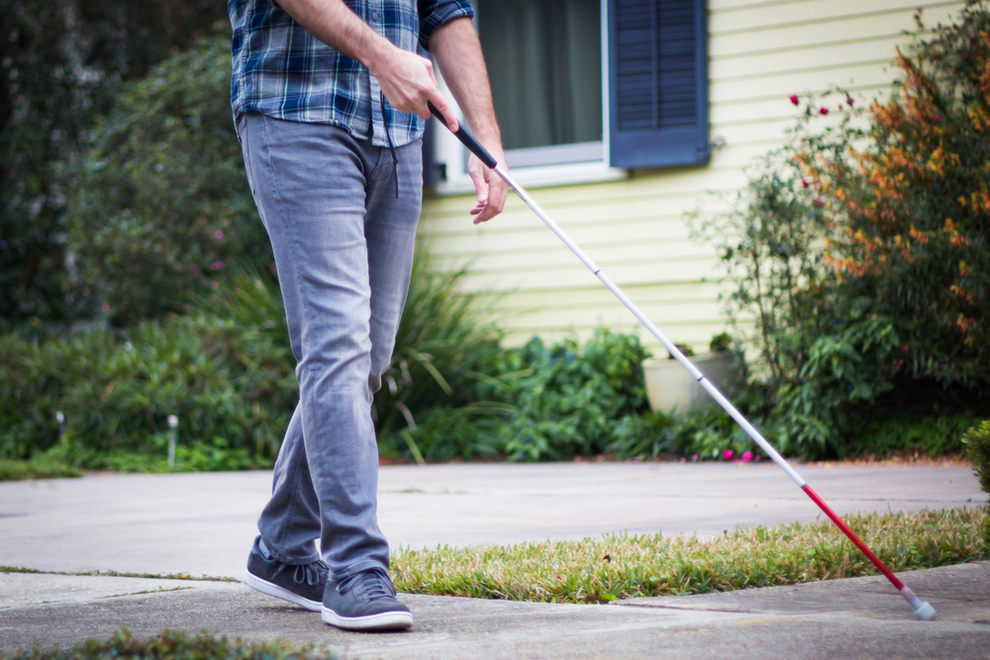 Blind man walking around neighborhood