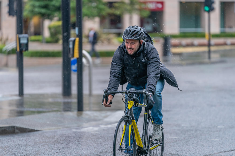 Man cycling in the rain