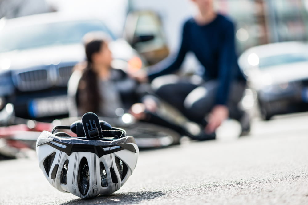 Bicycle helmet on roadway after crash illustrating importance of safety gear in San Diego