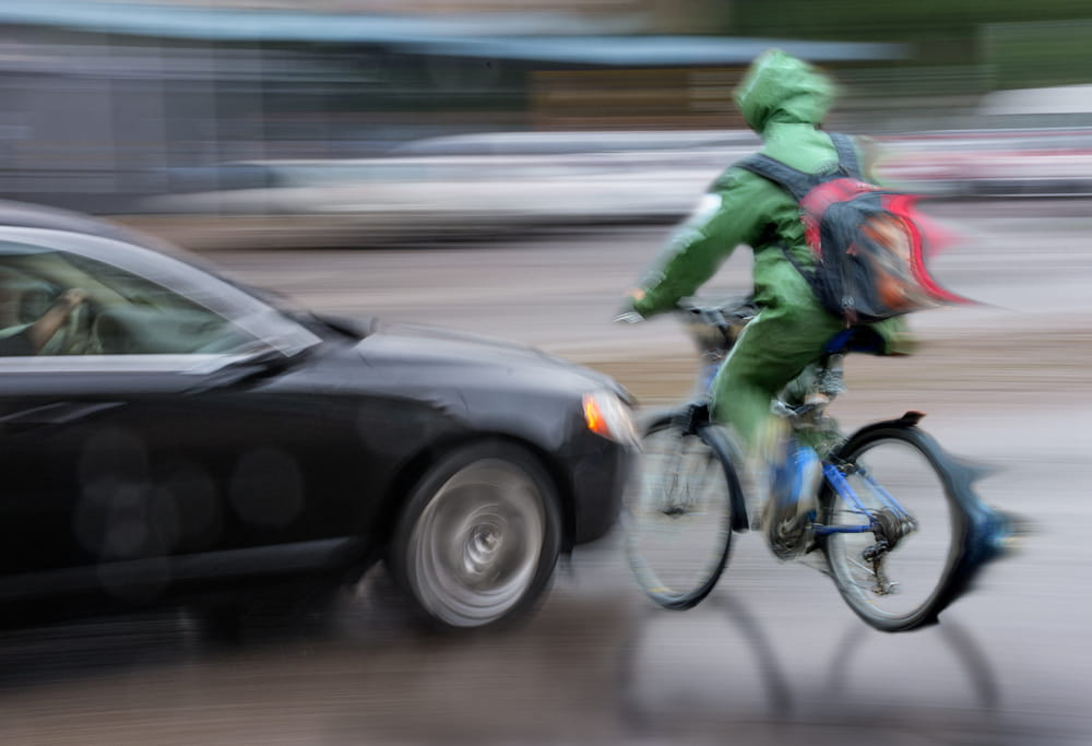 Car turning into cyclist illustrating right hook bicycle accident risk in San Diego